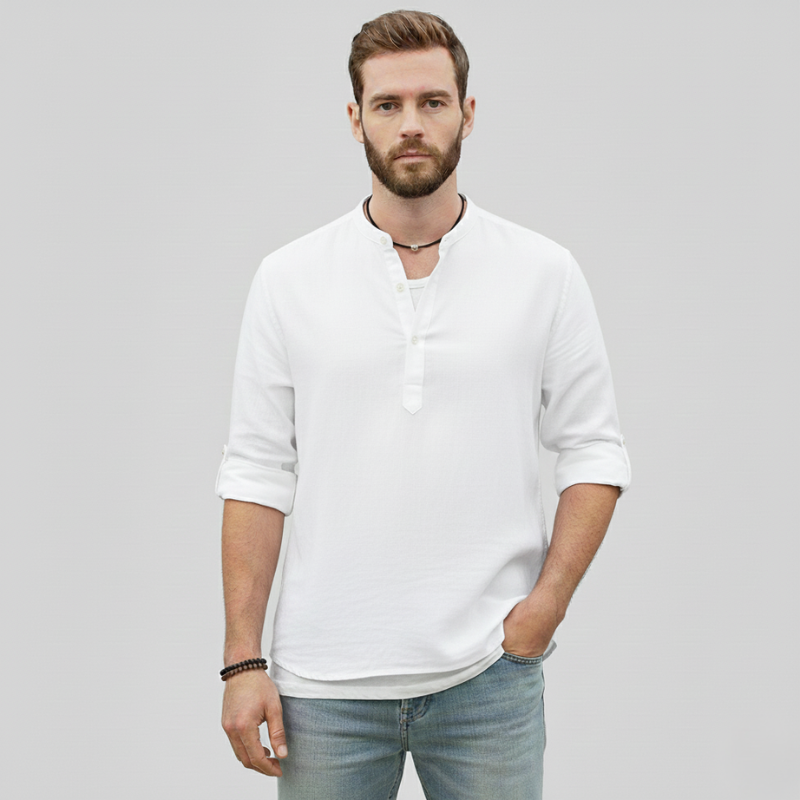Male model standing in a white linen shirt with a breathable fabric and relaxed summer fit.