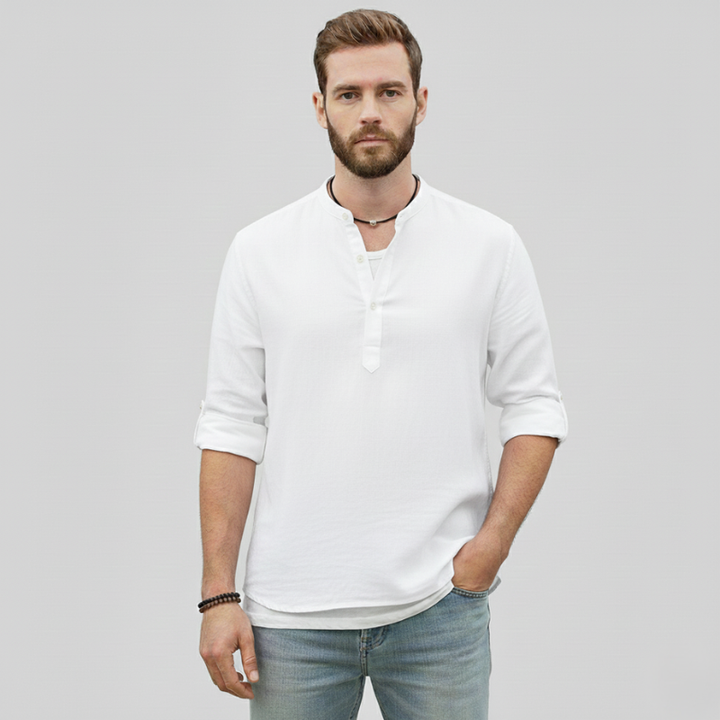 Male model standing in a white linen shirt with a breathable fabric and relaxed summer fit.