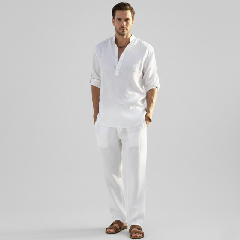 Full-body photo of a man wearing a white linen button-down shirt with matching pants in soft natural studio light.