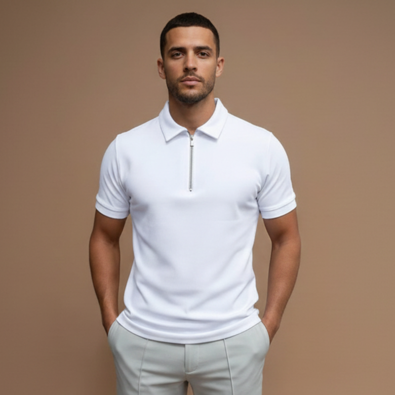 Man wearing a white short-sleeve polo shirt with a clean minimal collar design in soft indoor studio lighting.