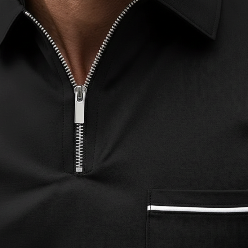 Close-up of a black quarter-zip shirt showing the zipper, stitching, and clean collar detail.