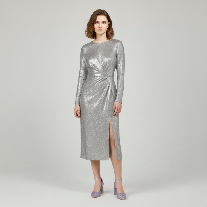 Woman wearing a silver sequin dress on a plain background