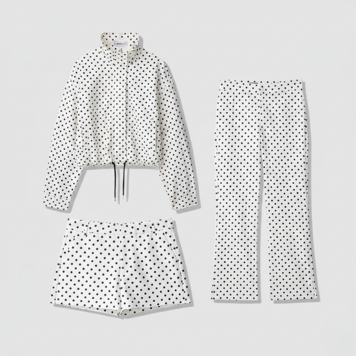 Polka dot outfit with jacket, pants, and shorts on a light gray background
