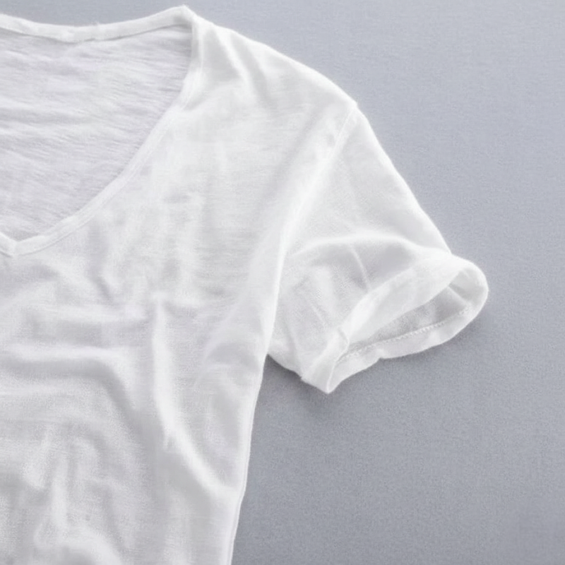 Close-up of a white V-neck T-shirt showing soft cotton texture and lightweight stretch material.