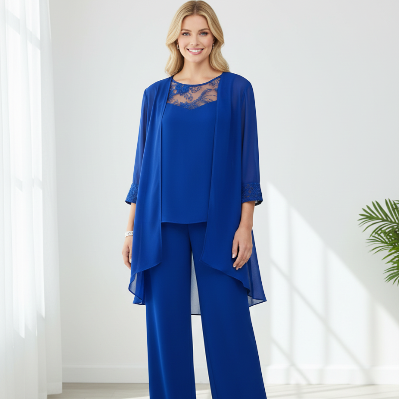 Woman standing indoors wearing a royal blue chiffon pant set with lace neckline for formal events.