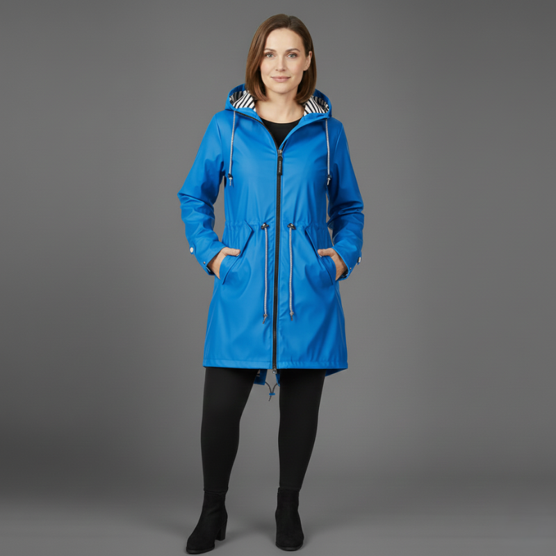 Woman standing in a blue hooded coat designed for cold weather.