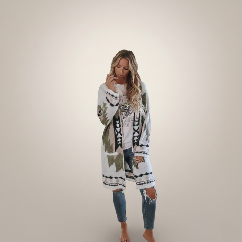 Female model wearing a boho-inspired tribal knit cardigan in soft natural window lighting.