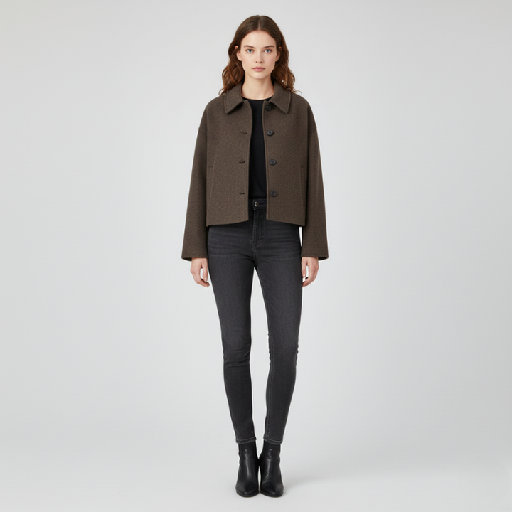 Woman wearing a brown jacket and black pants on a white background