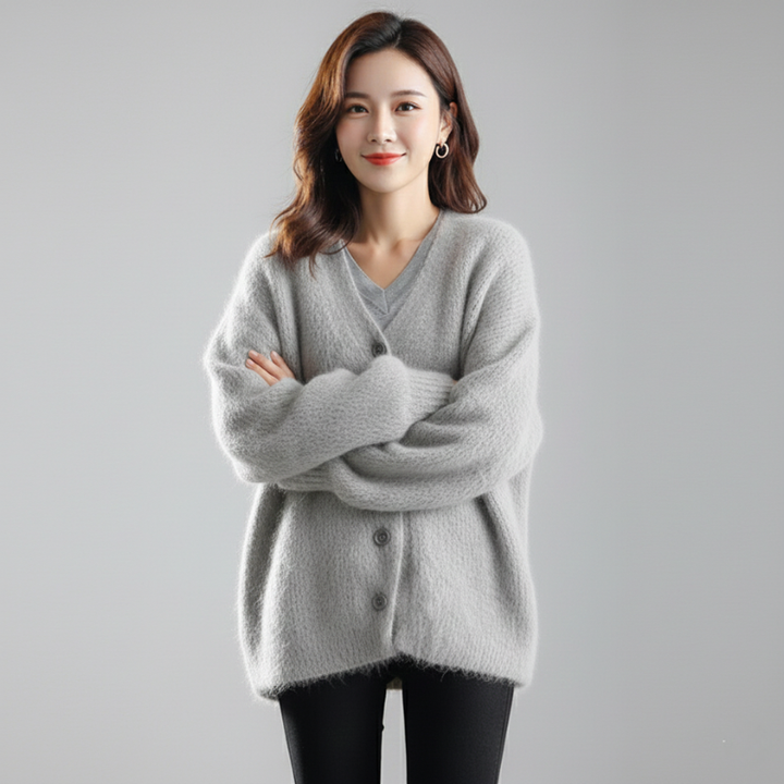 Female model in a casual gray knit cardigan with a loose silhouette and soft textured fabric.
