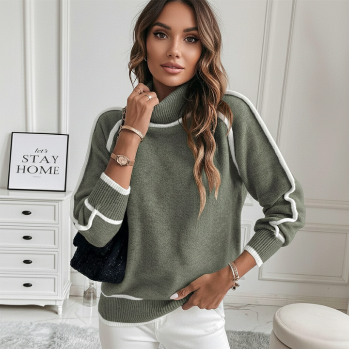 Woman posing in a green contrast-trim knit sweater featuring a relaxed fit and modern mock neck design.