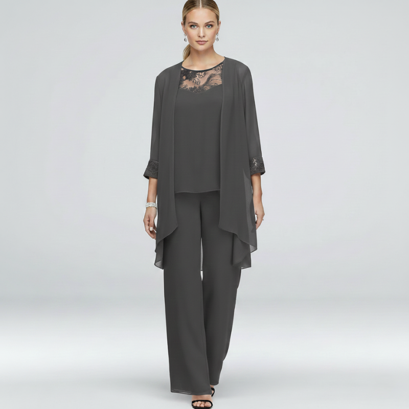 Woman wearing a gray two-piece chiffon pant suit with lace neckline and flowy layered top.