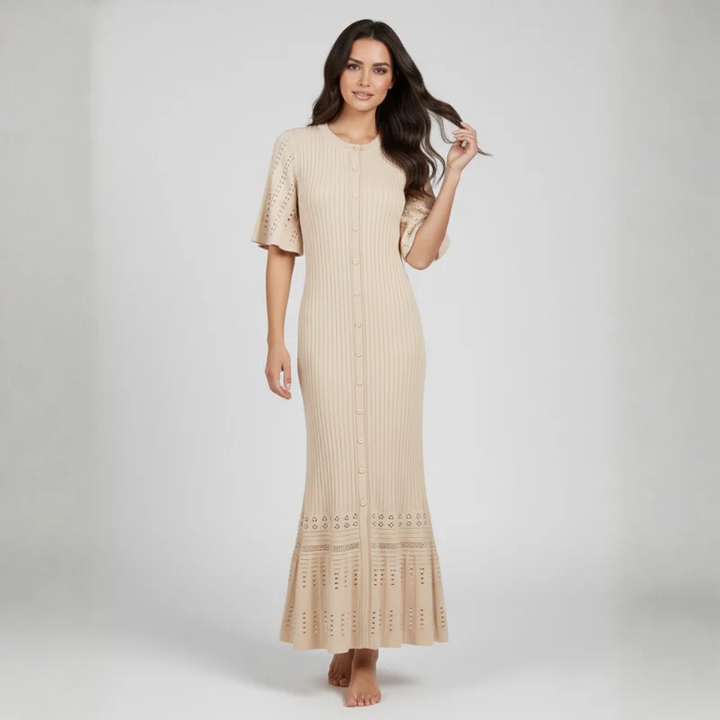 Woman wearing a beige dress with lace details on a white background