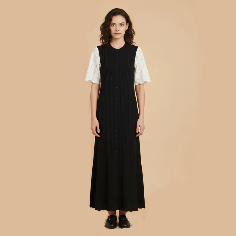 Woman wearing a black dress with white sleeves on a beige background