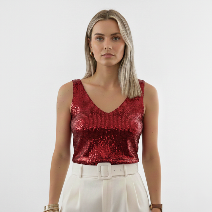 Woman wearing a red sleeveless sequin top with a V-neck design in soft indoor studio light.