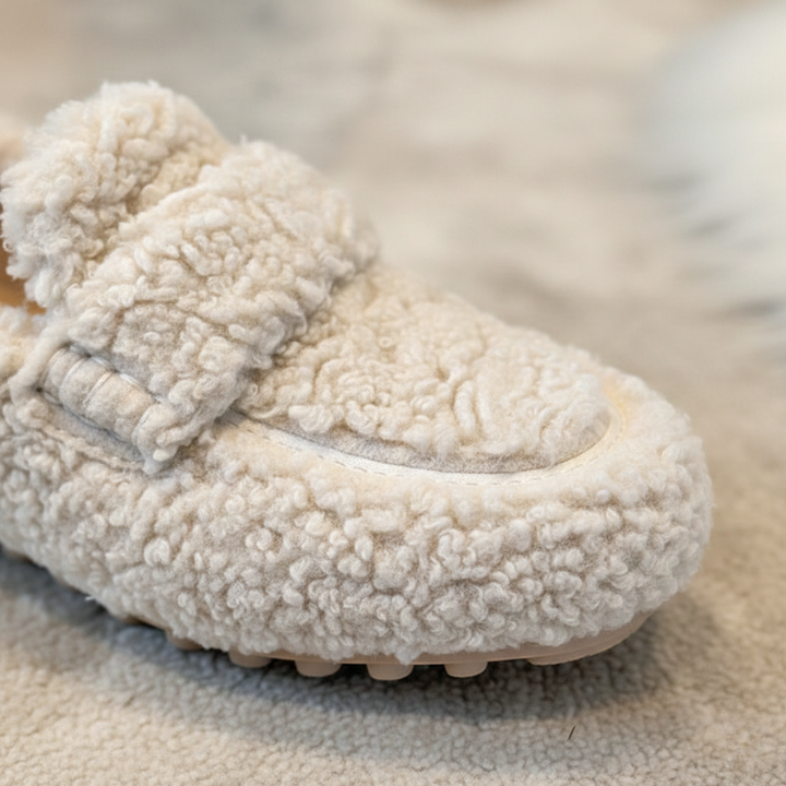 White fuzzy shoe on a textured surface