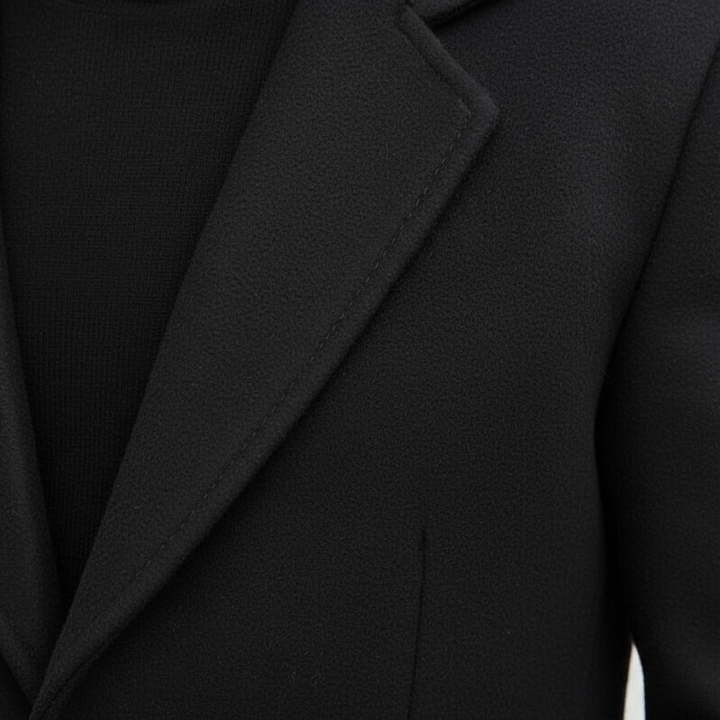 Close-up of a black blazer with a focus on the lapel and collar.